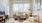 living area with a couch, coffee table and large window in the background